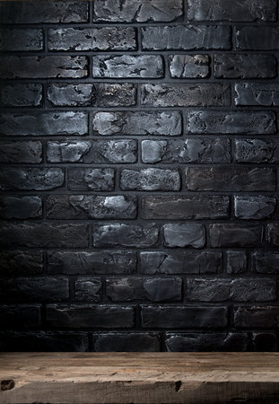 Black brick wall and old wooden tableの写真素材