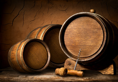 Wooden barrels and corkscrew in clay cellarの写真素材