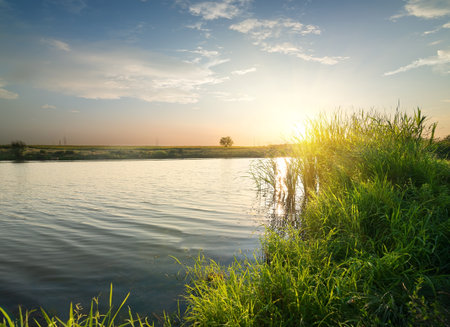Quiet river at sunset in late summerの写真素材