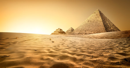 Egyptian pyramids in sand desert and clear skyの写真素材
