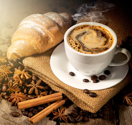 Morning coffee and croissant with spices on tableの写真素材