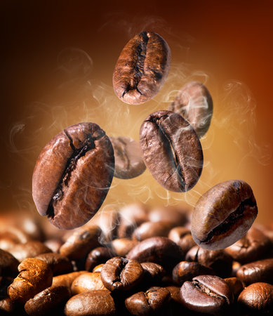 Grains of roasted coffee on an orange backgroundの写真素材