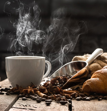 Hot coffee and croissant on old wooden tableの写真素材