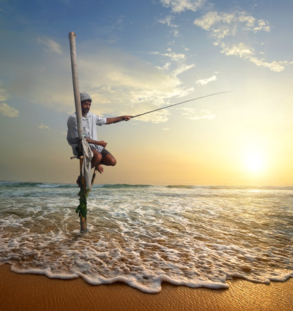 Local fisherman on stick on a beach of Indian ocean, Sri Lankaの写真素材