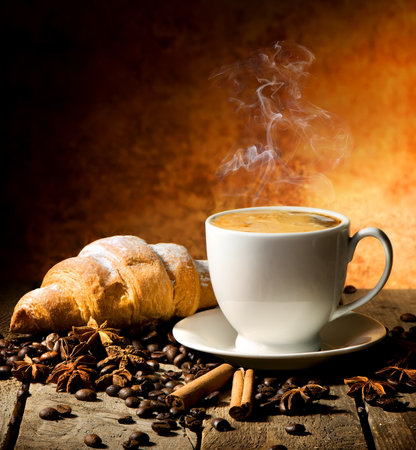 Fresh croissant and coffee with spices on tableの写真素材