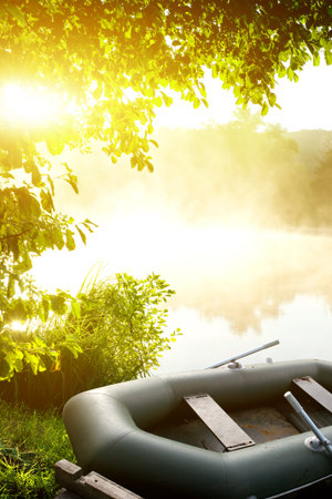 Inflatable fishing boat on the bank of a riverの写真素材
