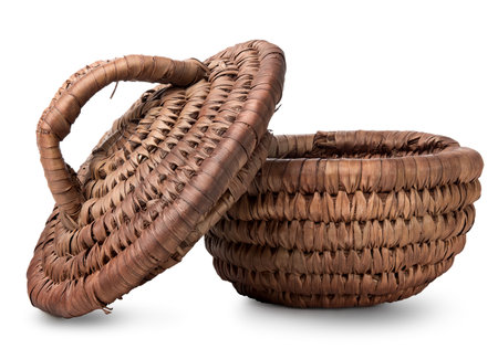 Opened wicker basket isolated on a white backgroundの写真素材