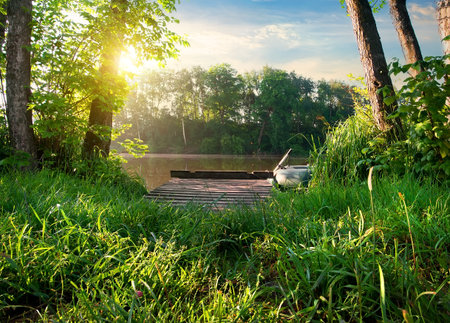 Small fishing pier on a river at sunriseの写真素材