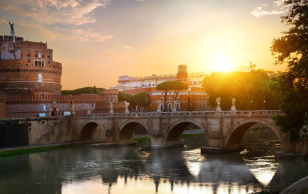 Fog on Tiber river and St Angelo bridge at sunrise, Italyの写真素材