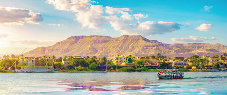 River Nile and ship at sunset in Luxorの写真素材
