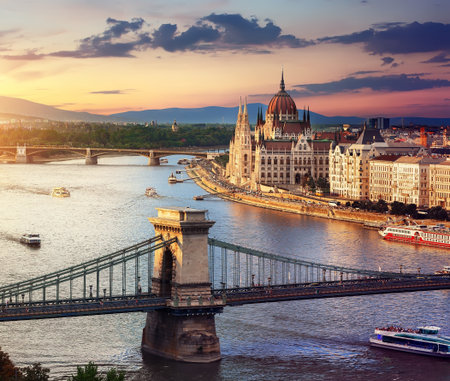 Parliament and famous bridges of Budapest at sunset, Hungaryの写真素材