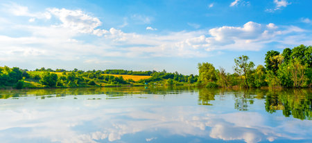 Landscape pond and forest in spring afternoonの写真素材