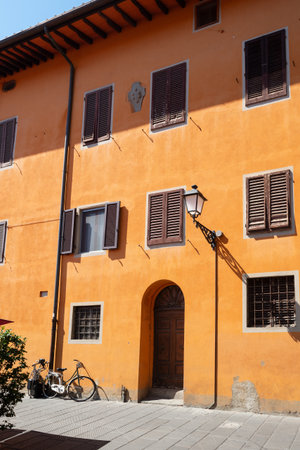 Brightly painted house in orange. Stunning colorful background. Pisa, Italyの写真素材