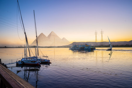 Nile River and boats at sunset in Luxor and pyramidsの写真素材