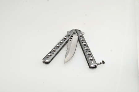 This sharp metal is a folding knife made of silver which is commonly used for self defense