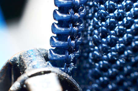 hard plastic jacket zippers, shaped like teeth arranged in long lines down in blue