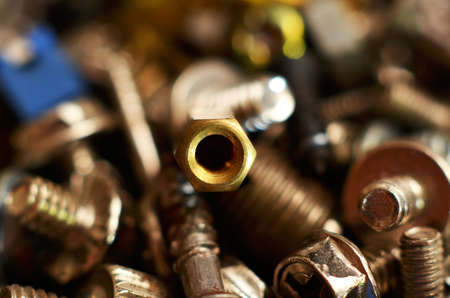 Screw made of iron and brass in the shape of a round rod extends with the thread from end to top called a round head that is larger than the size of the threaded rodの写真素材
