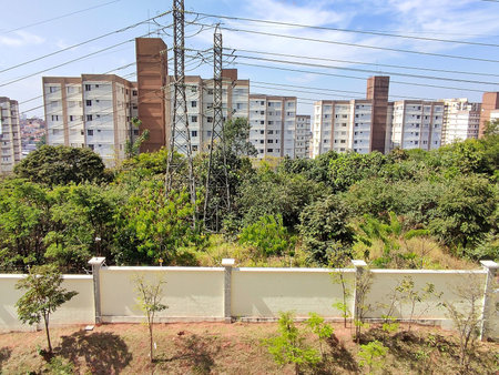 Buildings amid vegetation and antennas on a sunny day with blue skyのeditorial素材