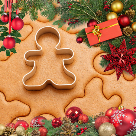 Christmas backdrop with cookie shapes with present and red christmas ballsの写真素材