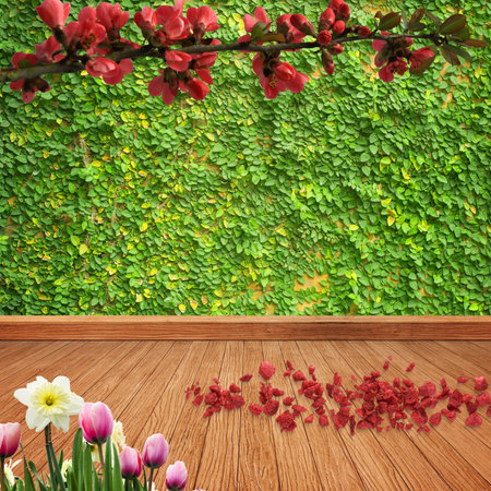 Background of green leaves and wooden floor with a branch with red flowers and petals on the ground and pink and white flowers surrounded by green foliageの写真素材