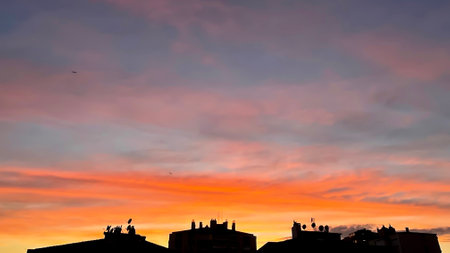 Sunset sky background. Twilight sky. Colorful skyline evening sunset with buildings.の写真素材