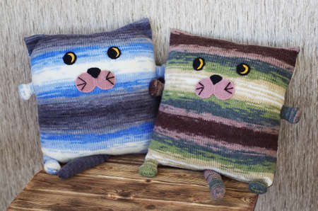 Two knitted pillow in the form of catsの写真素材