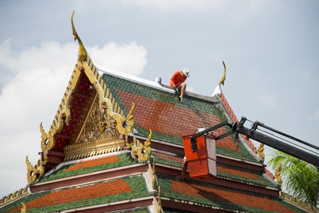 Men repair roof of Temple
