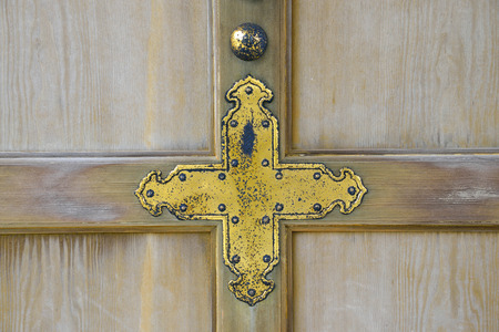 Golden cross on wooden wallの写真素材