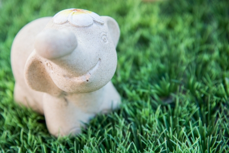 A little elephant figure on green grassの写真素材