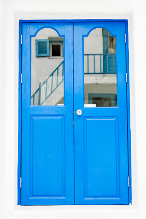 Blue wooden door on white wallの写真素材