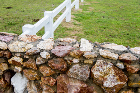 Stone wall and wooden fence