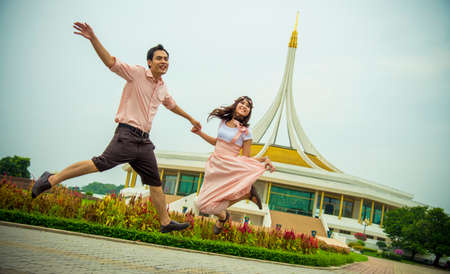 Lovely couple jump up togetherの写真素材