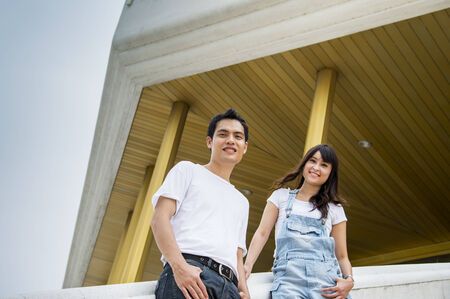 Lovely couple stand on the stairs