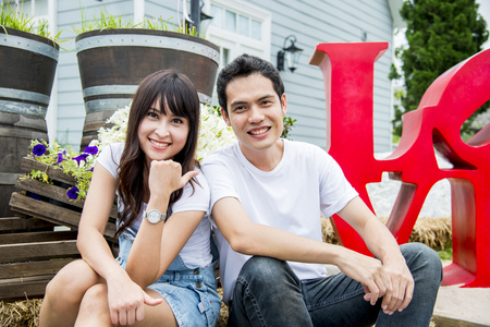 Lovely couple sit and smile togetherの写真素材