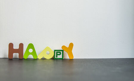 Colorful wooden word Happy with white backgroundの写真素材