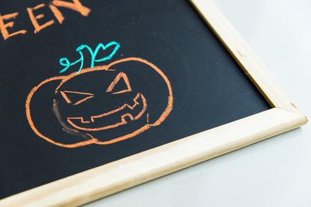 Halloween pumpkin on black boardの写真素材