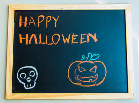Happy halloween on black board with pumpkin1の写真素材