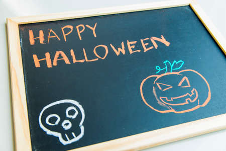 Happy halloween on black board with pumpkin2