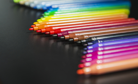 Wave of colorful makers on black backgroundの写真素材