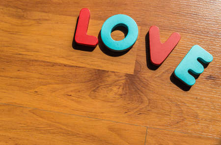 Wooden word LOVE on laminate floorの写真素材