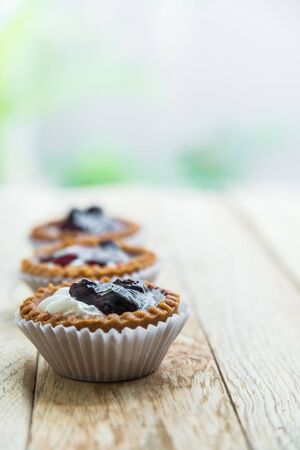 Three Blue berry tart on wooden floor 5の写真素材