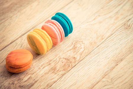 Colorful macaroons on wooden floor in Vintage styleの写真素材