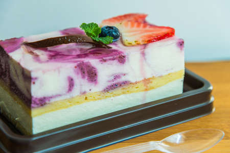 Blue berry cheese cake on wooden plateの写真素材