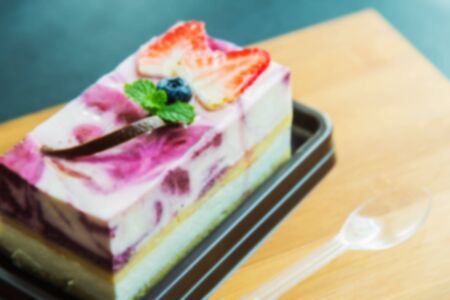 Blue berry cheese cake on wooden plate in Blur styleの写真素材