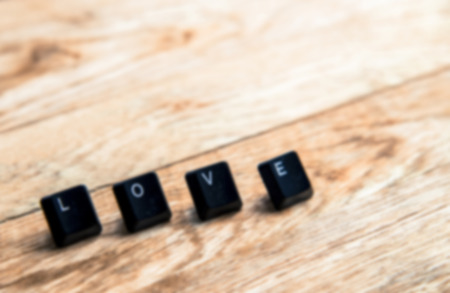 Love word on the wooden floor in Blur styleの写真素材