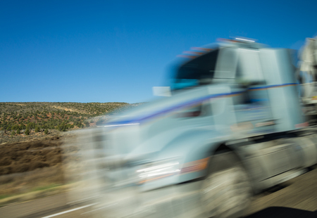 Blured truck drive with the blue skyの写真素材