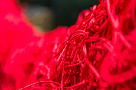 Knot of red rope for lovely couple wish in Temple with selective focusの写真素材