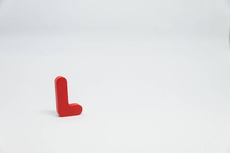 Red Wooden alphabet L with white backgroundの写真素材