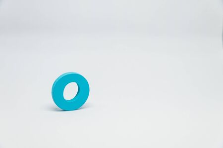 Blue Wooden alphabet O with white backgroundの写真素材