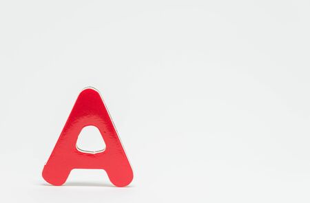 Red wooden alphabet A with white background and selective focusの写真素材